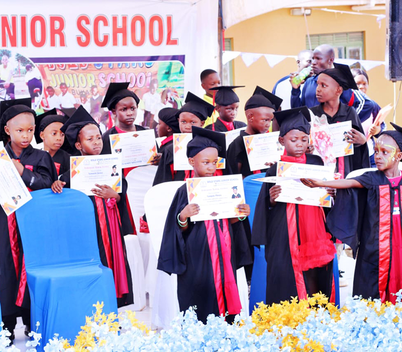 Happy nursery children at BoldStars Junior School holding graduation certificates